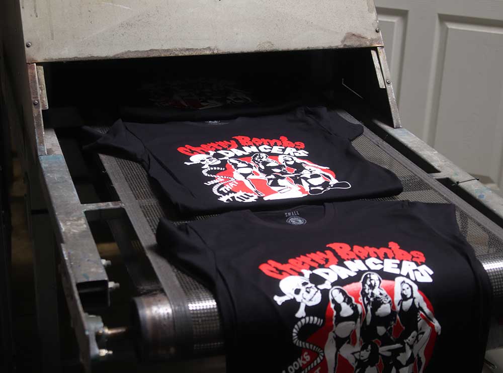 bulk ordered shirts on a conveyor belt dryer