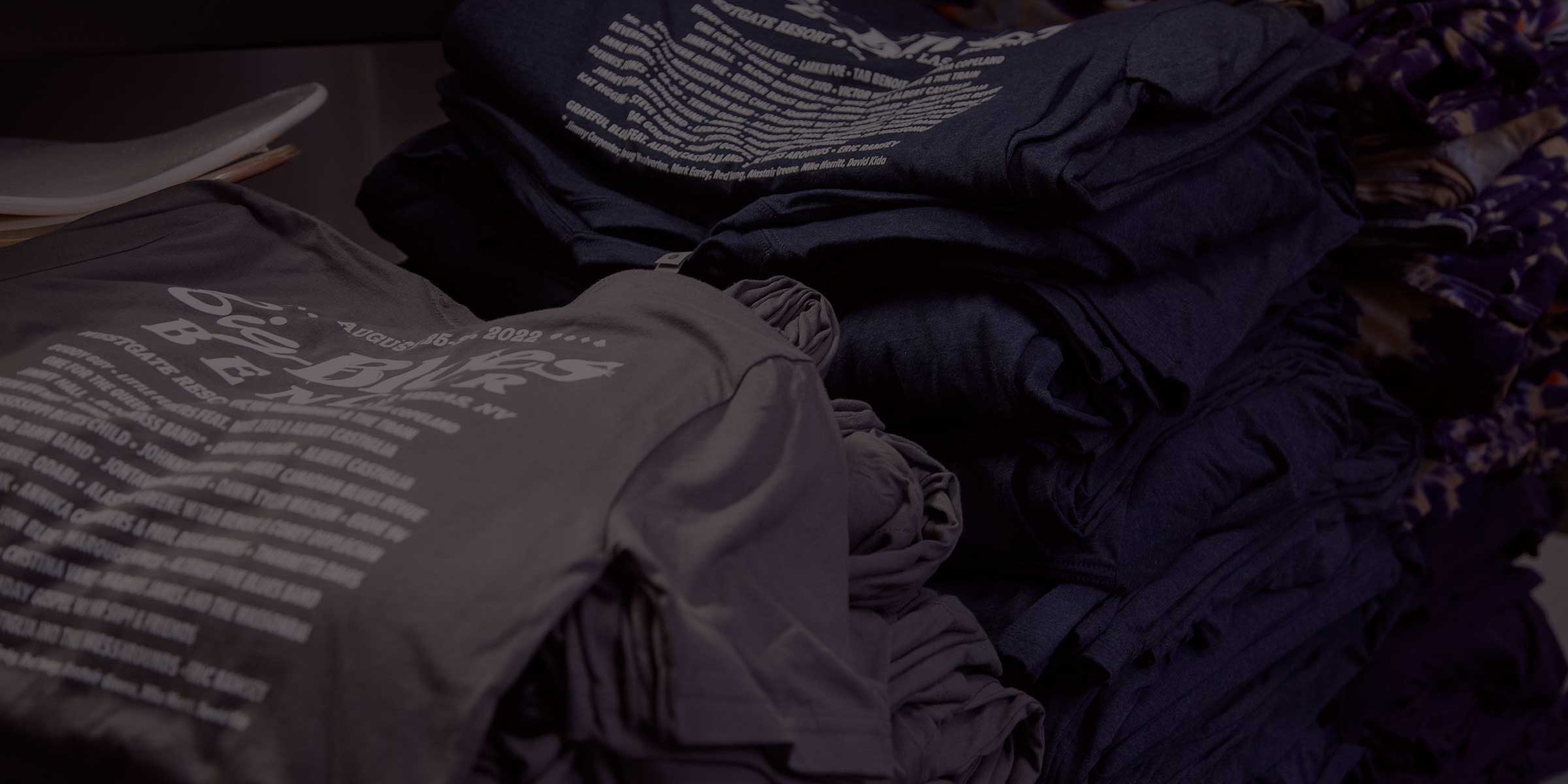 large stacks of wholesale screen printed shirts for contract printing clients